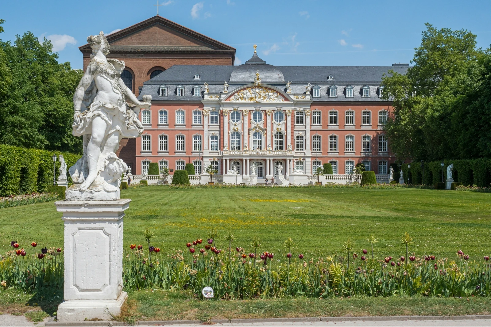 Kurfürstliches Palais in Trier mit Garten und Statue.